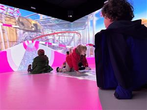 Children inside the Immersive Room on a waterslide simulation